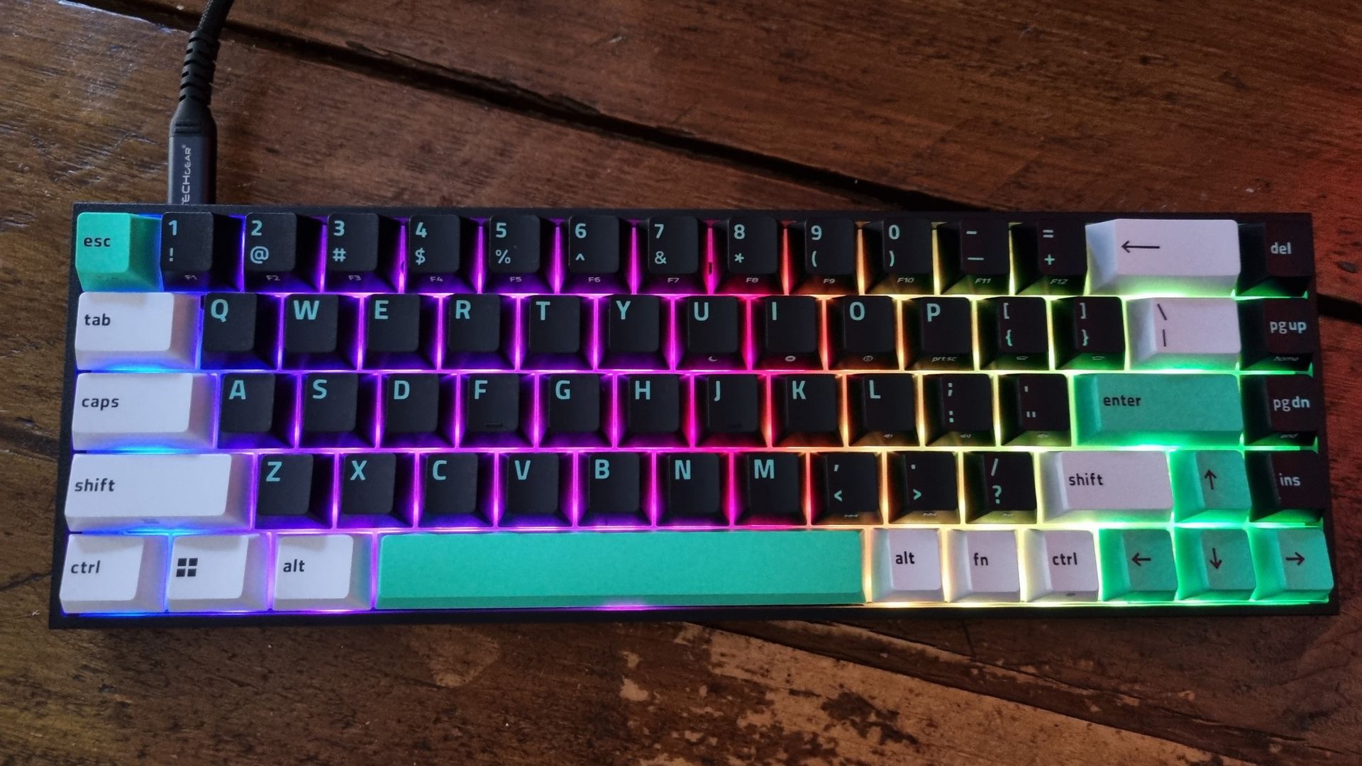 A Razer Reclusa X Mini 65% gaming keyboard shot from above, on a wooden desk