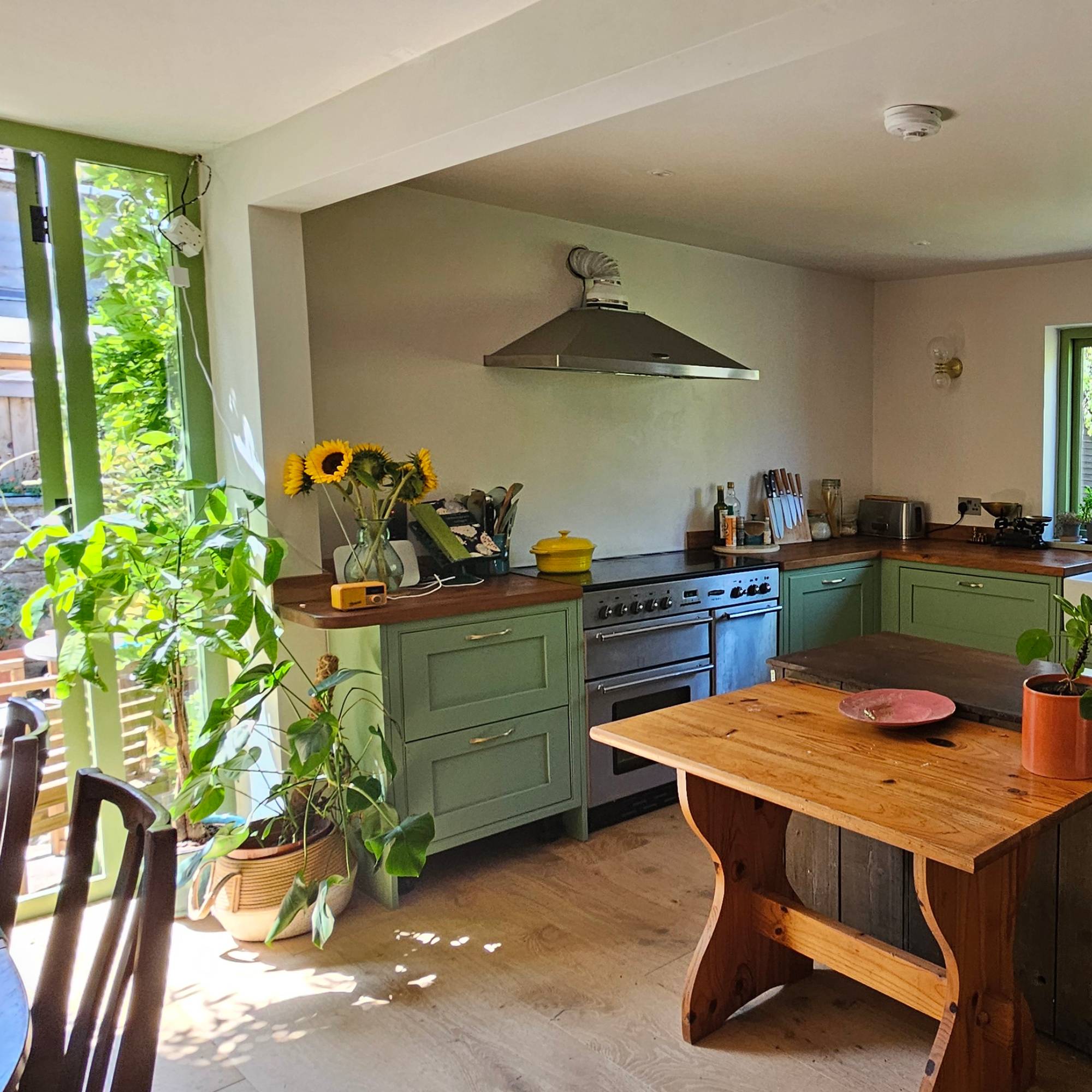 green kitchen with temporary island