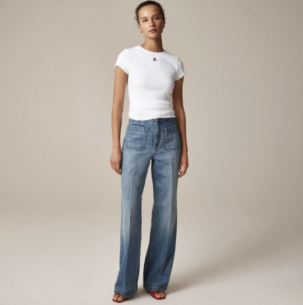 a model wearing a jcrew tshirt with jeans and sandals
