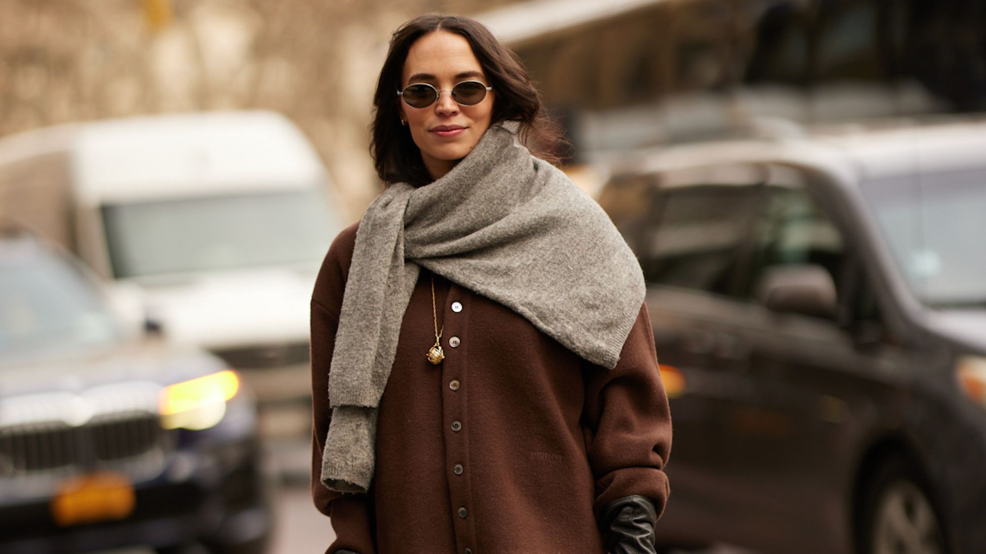 a woman wearing a cashmere cardigan and jumper during fashion week