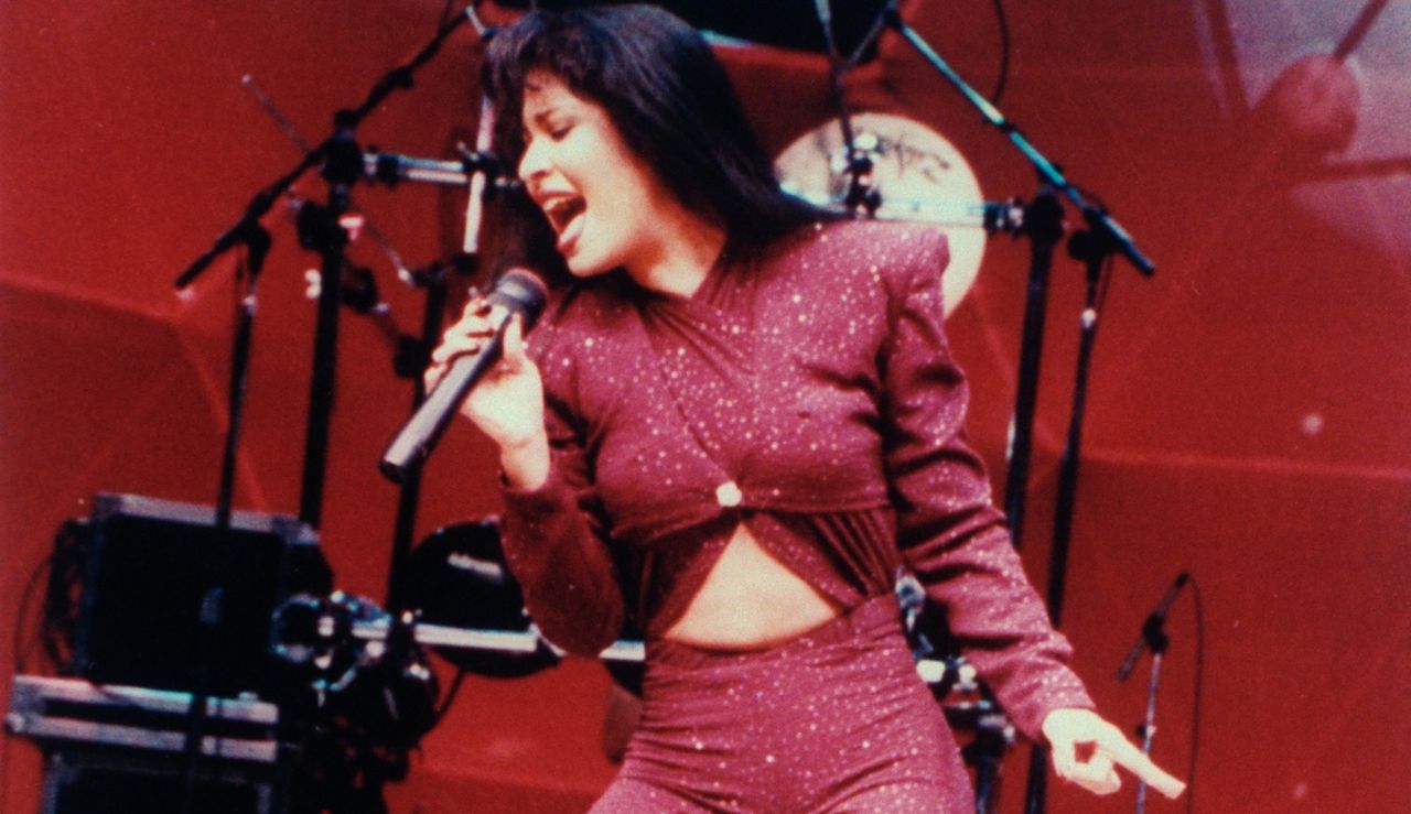 Mexican singer Selena performing in concert; one month later she would be shot and killed by Yolanda Saldivar, the pres. of her fan club, after confronting her on charges that she was embezzling funds. 