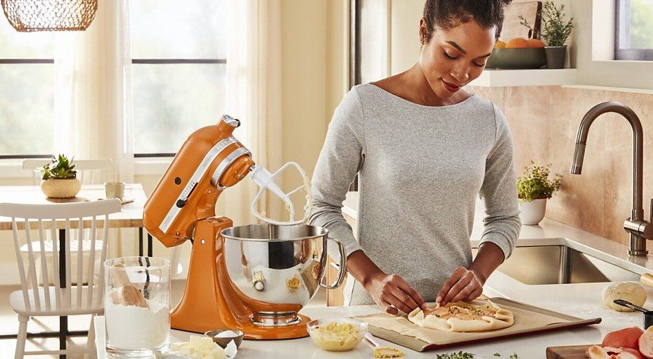 Woman using KitchenAid mixer in kitchen