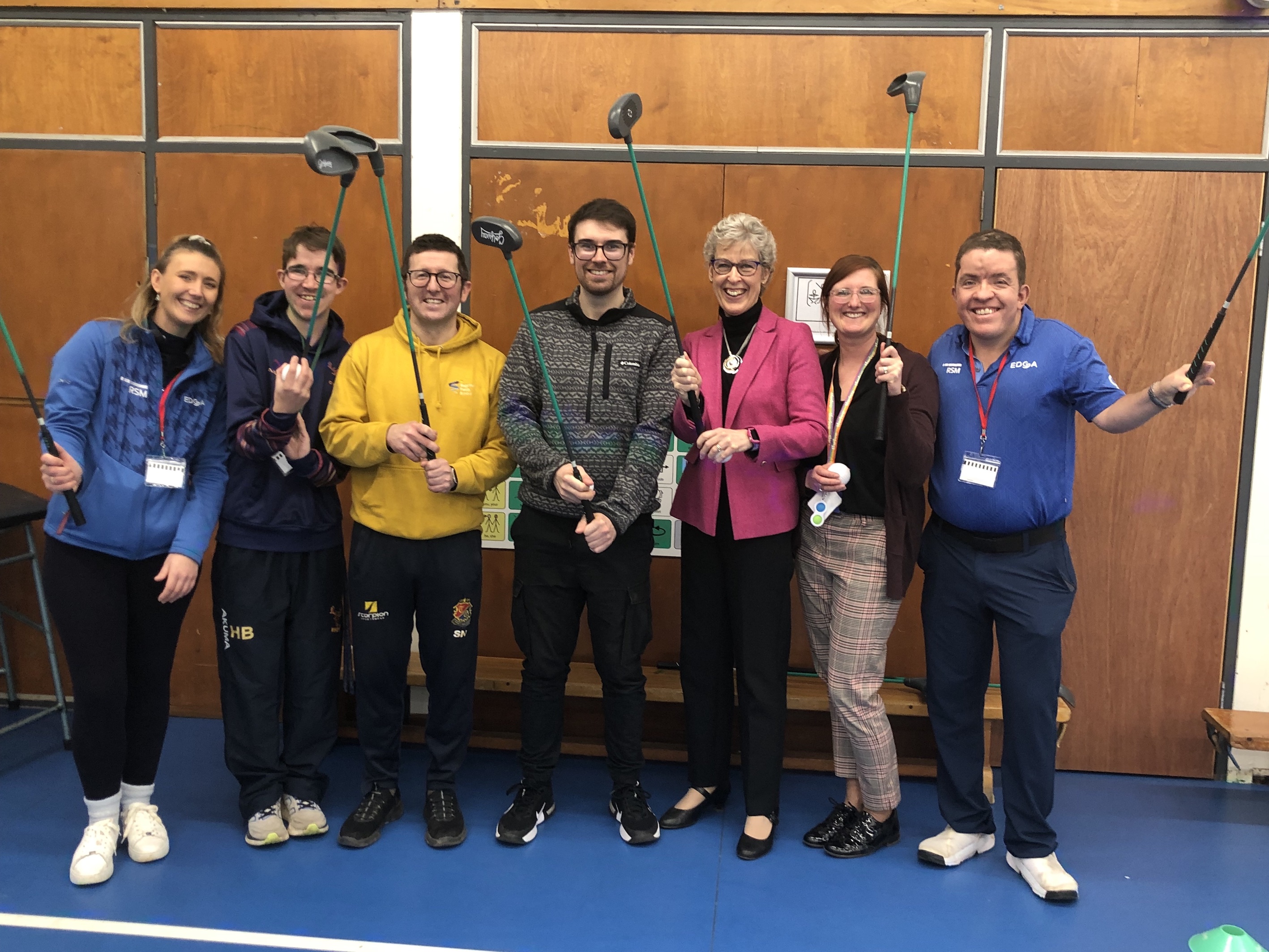 School teachers posing for a photo after an indoor golf session