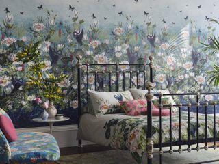 Colourful flower, bird and butterfly wallpaper, patterned bedsheets and armchair