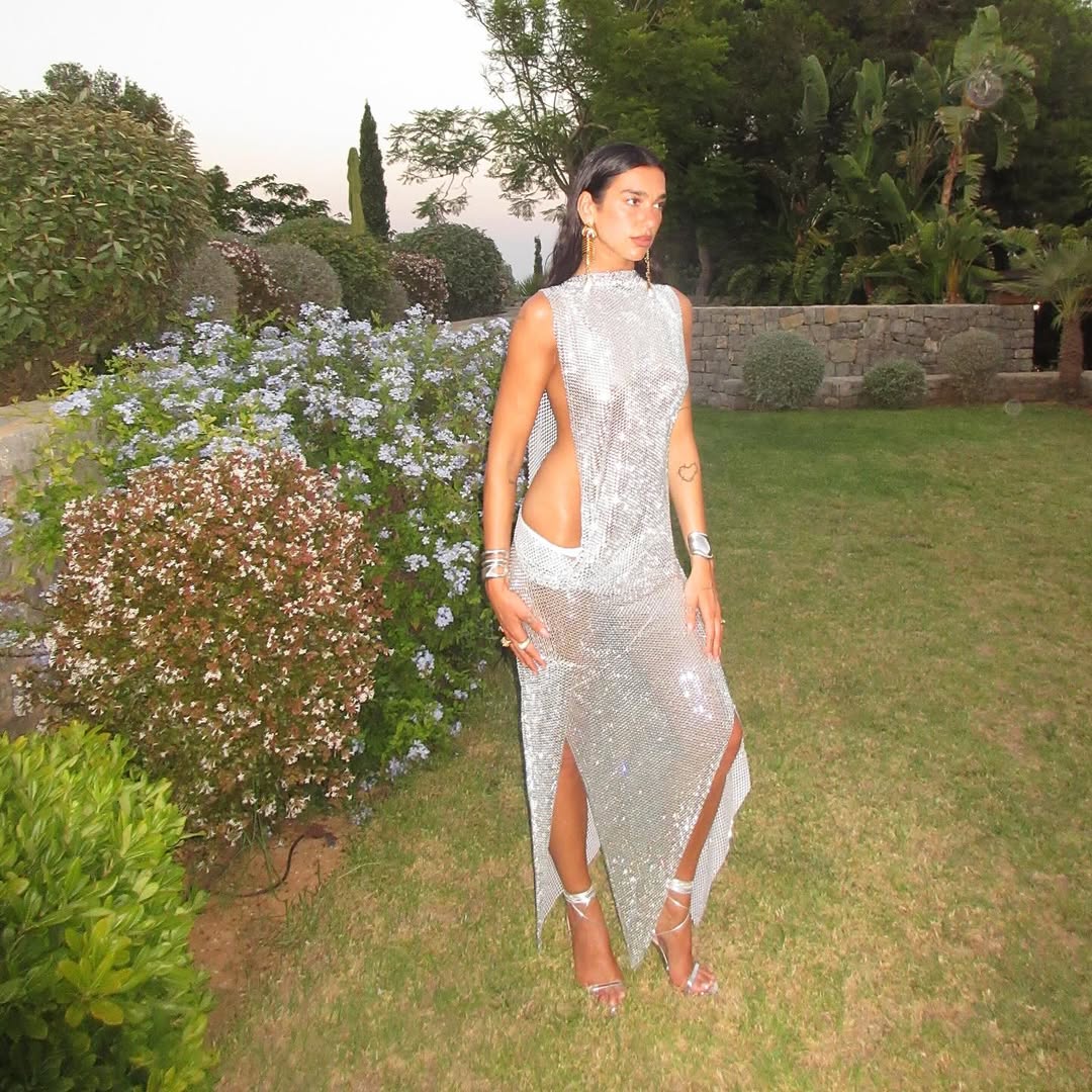 Dua Lipa celebrates her 30th birthday in a custom silver chainmail dress with side splits and open side torso