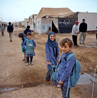 More than half of Zaatari's population is under 18. These kids, making their way home from school, are some of the 60,000 children who call the camp home.
