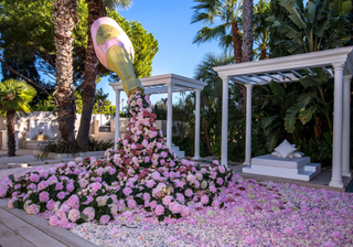 A pool filled with flowers at the Phillipl Plein event in Cannes