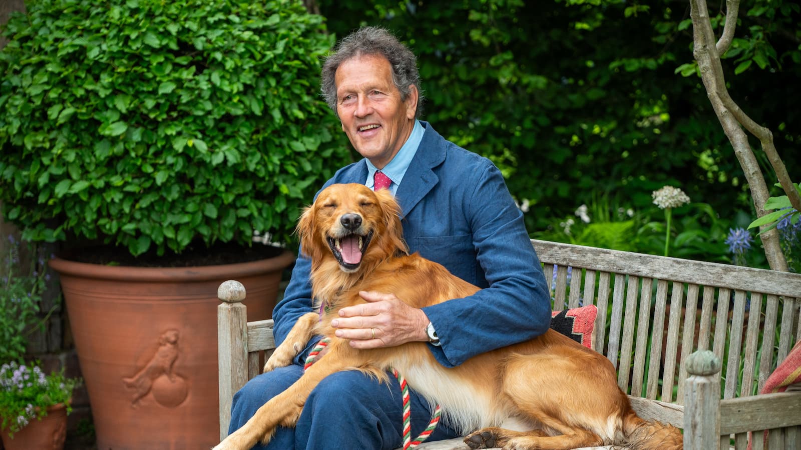 Monty Don has an informal moment with his Golden Retriever Ned on the RHS and BBC Radio 2 Dog Garden at RHS Chelsea