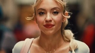 Sydney Sweeney walks down the hallway with her makeup done and her hair in a lot of little ties in Euphoria Season 2.