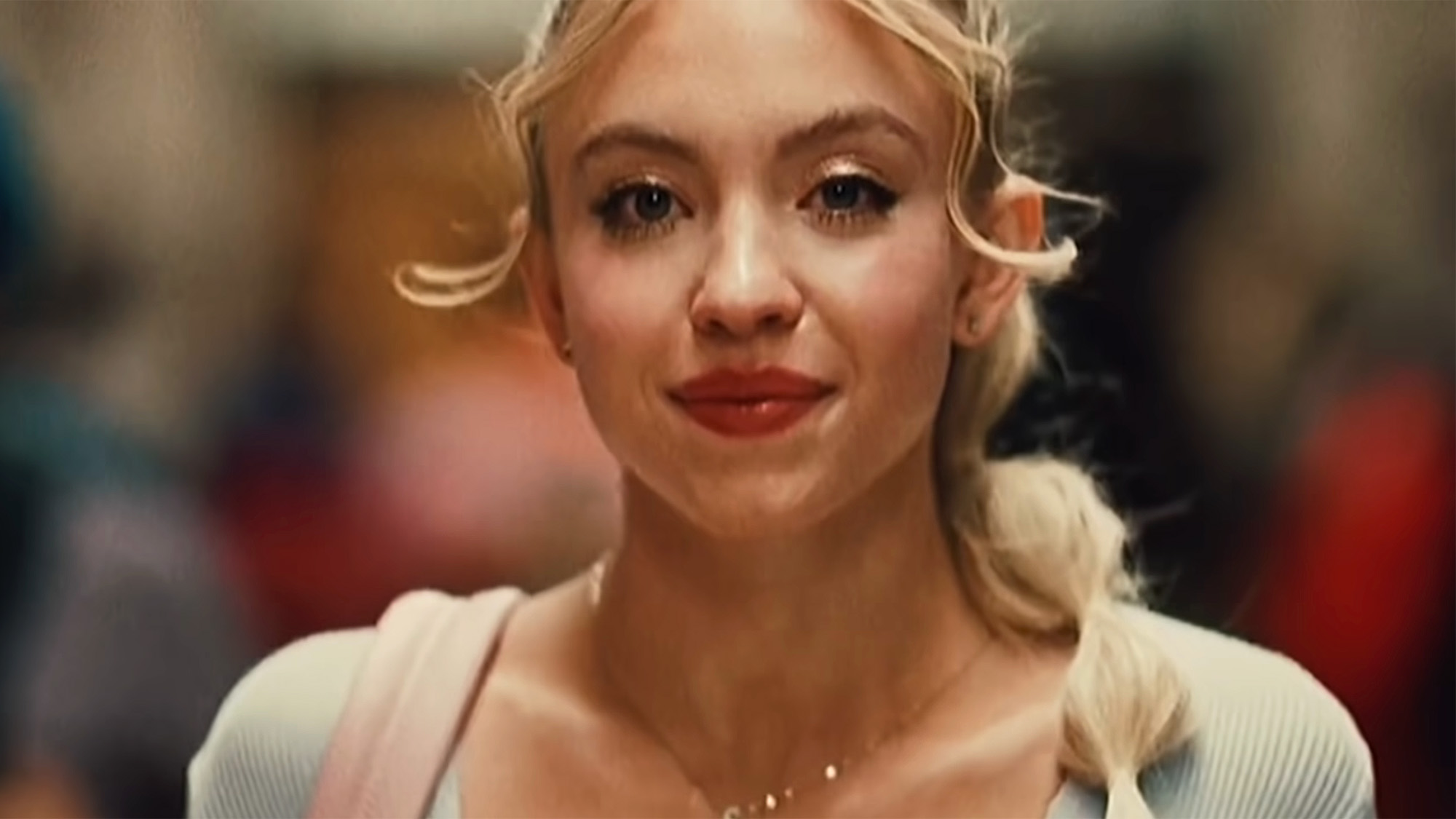 Sydney Sweeney walks down the hallway with her makeup done and her hair in a lot of little ties in Euphoria Season 2. 
