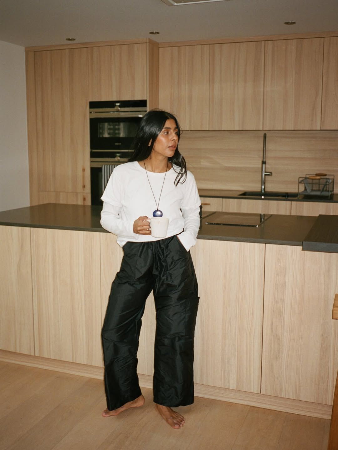 @monikh wears white T-shirt black trousers