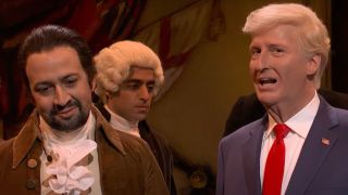 Lin-Manuel Miranda tries not to laugh as Trump talks on SNL.