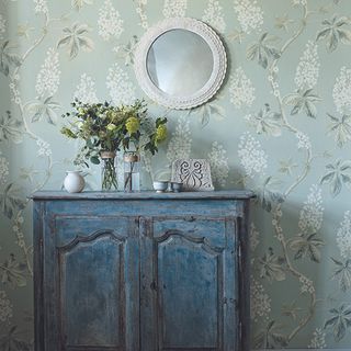 room with wallpaper and plant