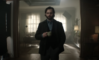 You season 4 star Penn Badgley as Joe Goldberg, holding a cup of tea