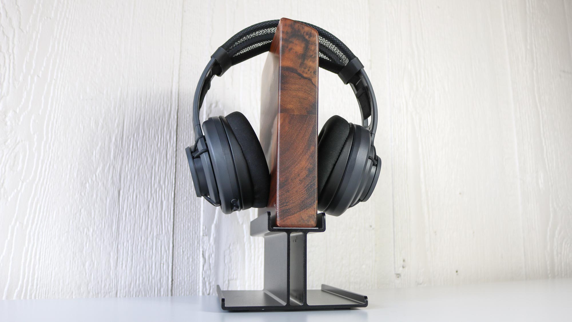 The Uplift headphone stand with open-ear headphones attached