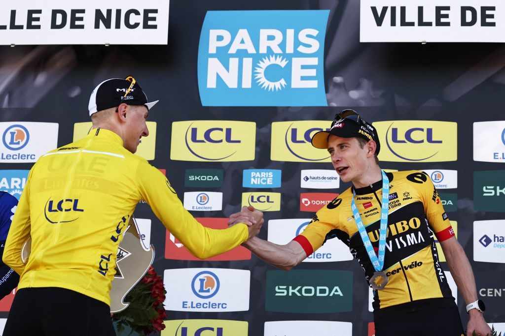 Overall winner UAE Team Emirates Slovenian rider Tadej Pogacar L wearing the overall leaders yellow jersey shakes hands with third placed JumboVismas Danish rider Jonas Vingegaard as they celebrate on the overall podium after the 8th and final stage of the 81st Paris Nice cycling race 1175 km between Nice and Nice in French riviera city of Nice southeastern France on March 12 2023 Tadej Pogacar won a third stage of the ParisNice race on March 12 2023 to take a crushing overall victory in his first entry to the prestigious eightday event Photo by AnneChristine POUJOULAT AFP Photo by ANNECHRISTINE POUJOULATAFP via Getty Images