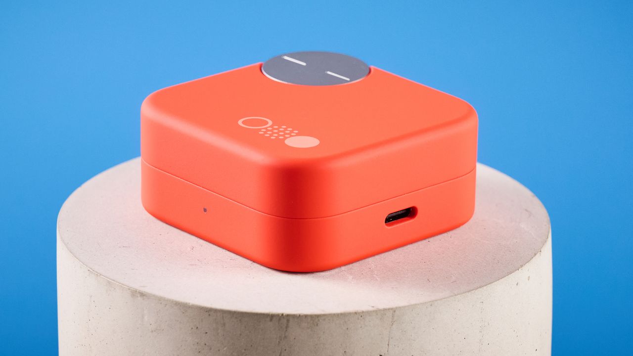 the nothing cmf buds pro 2 cmf by nothing buds pro 2 in bright orange shown in the smart dial charging case against a blue tom's guide background