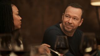 Donnie Wahlberg looking at new co-star Sonequa Martin-Green in the first Boston Blue family dinner scene