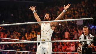 Seth Rollins enters the ring in a white and gold all-in-one outfit ahead of WWE Money in the Bank 2023 live stream