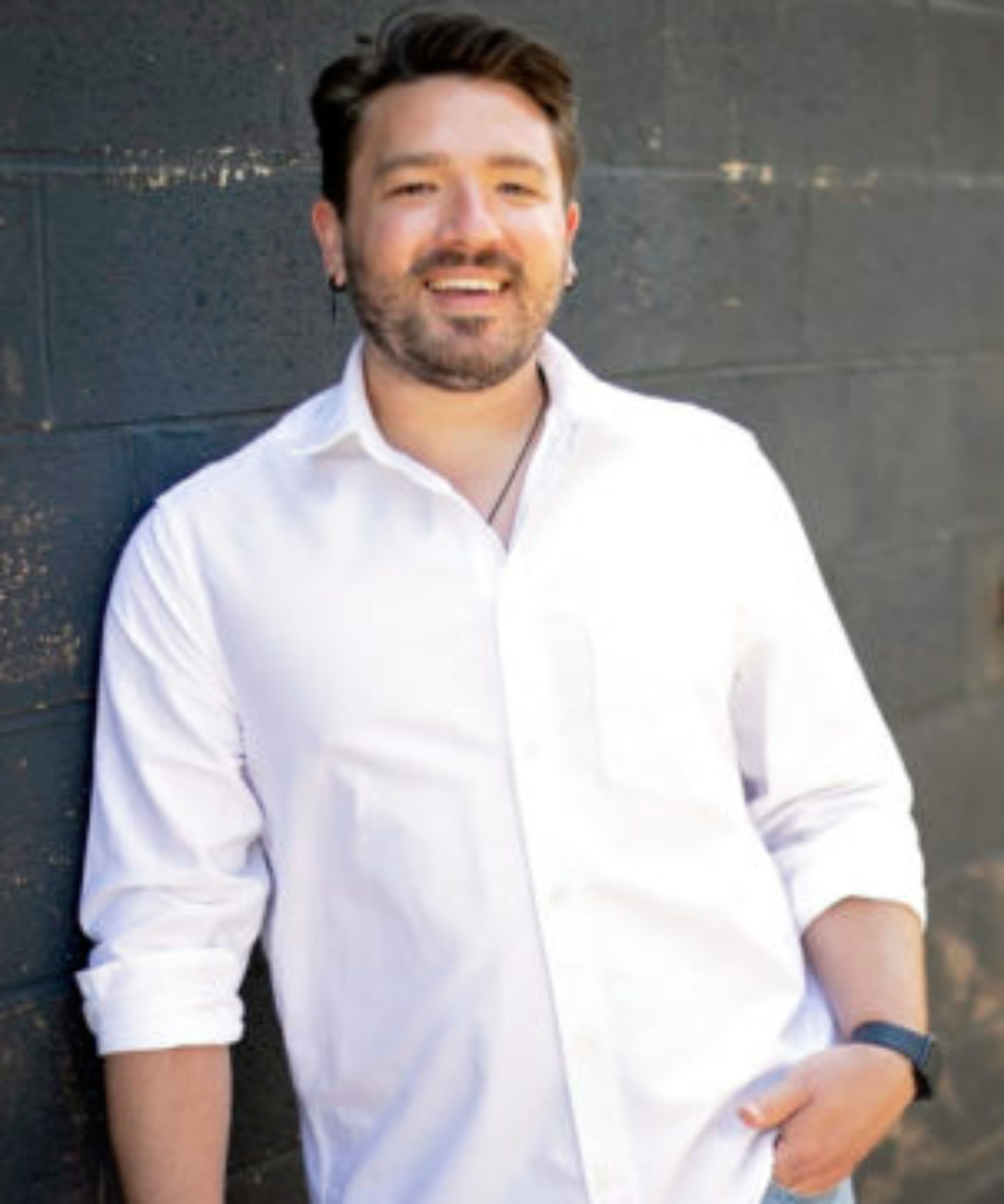 headshot of male with dark hair, short beard wearing white shirt