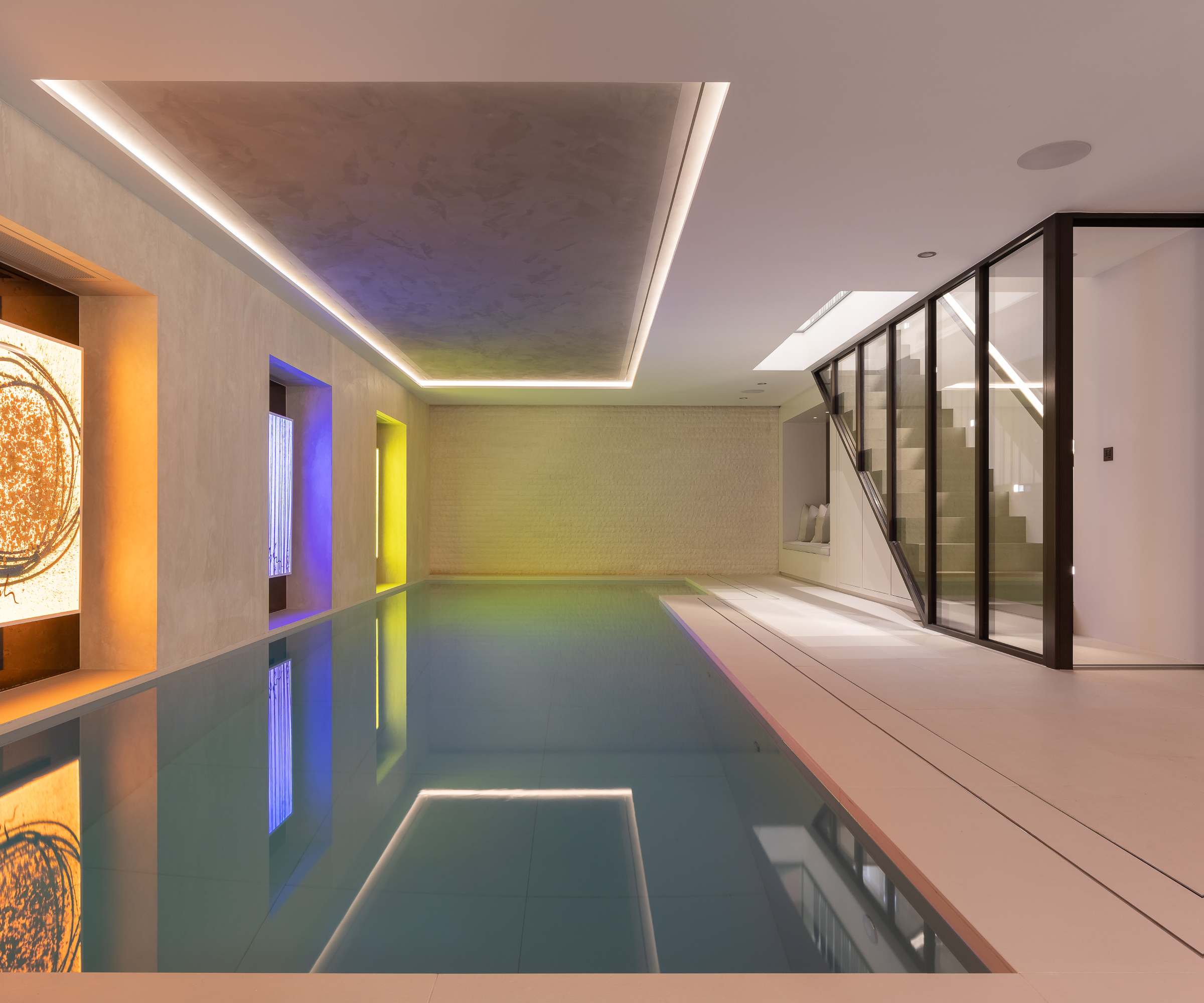 glazed windows and walls between stairwell and large indoor swimming pool