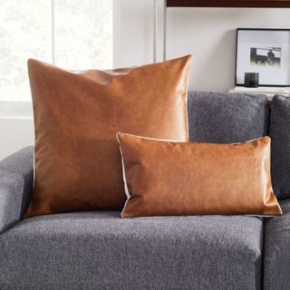 Leather Fall throw pillows on grey sofa 