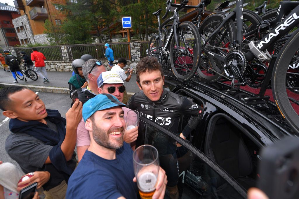 Geraint Thomas poses for photos with fans at the finish of stage 19