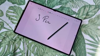 Samsung Galaxy Tab S9 Ultra 5G with stylus on top and a note open