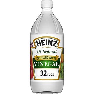 A bottle of Heinz All Natural Distilled White Vinegar with white, gold and green label