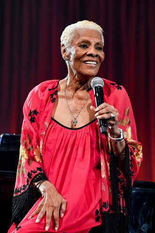 Dionne Warwick is pictured with grey hair whilst speaking onstage at the New York Restoration Project's 27th Annual Halloween Gala "Once Upon a Hulaween: Scarytales & Deadtime Stories" held at Cipriani South Street on October 27, 2023 in New York City.