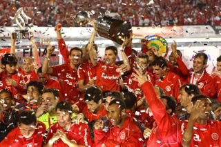 Internacional players celebrate with the trophy after winning the Copa Libertadores in August 2010.
