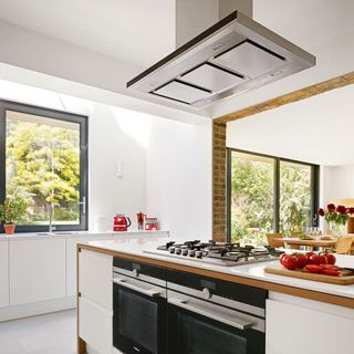 kitchen with kitchen chimney and white walls