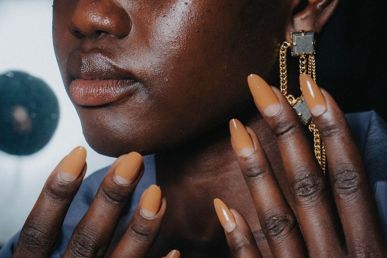 Various women with neutral colored manicures.