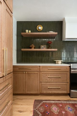 Wooden kitchen with olive green tiles