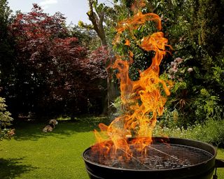 A barbecue with tall flames