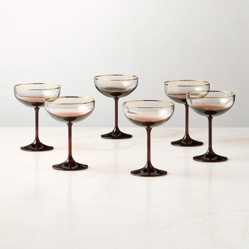 Coupe glasses with red stems and gold rims