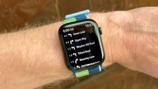 Apple Watch Series 7 with Footpath directions on the screen.