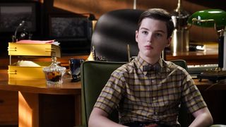 Iain Armitage sits in a chair in Young Sheldon