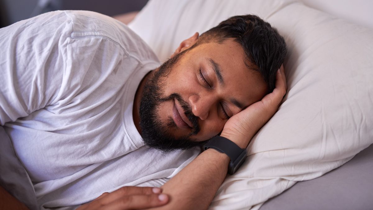 Man sleeping wearing a fitness tracker