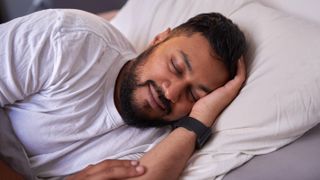 Man sleeping wearing a fitness tracker