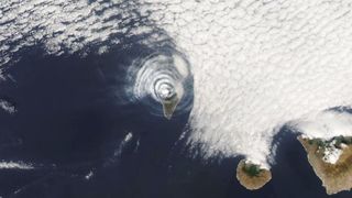 A satellite image of the concentric cloud rings above La Palma created by its erupting volcano.