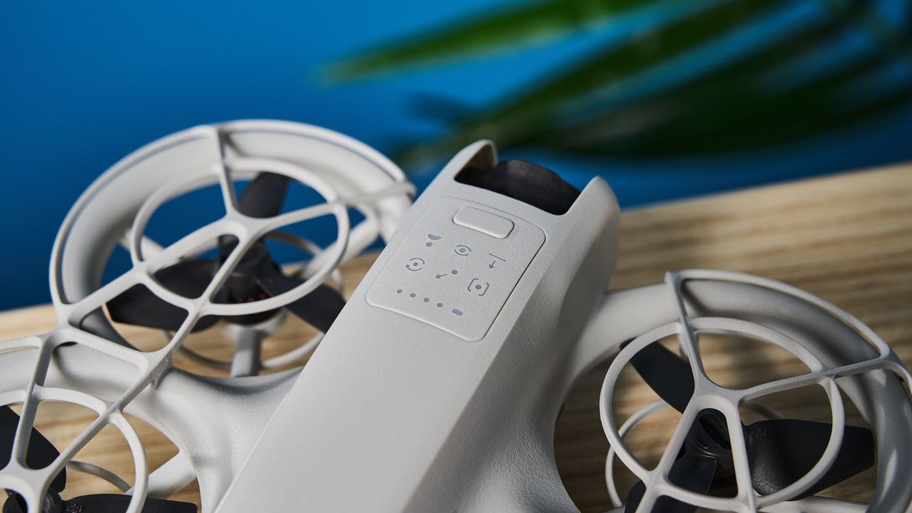 A gray DJI Neo drone with a camera