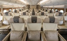 view of the interior of an aeroplane cabin featuring a beige design