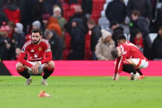 Manchester United players look dejected at full time after a 3-0 defeat at home to Bournemouth in the Premier League in December 2024.