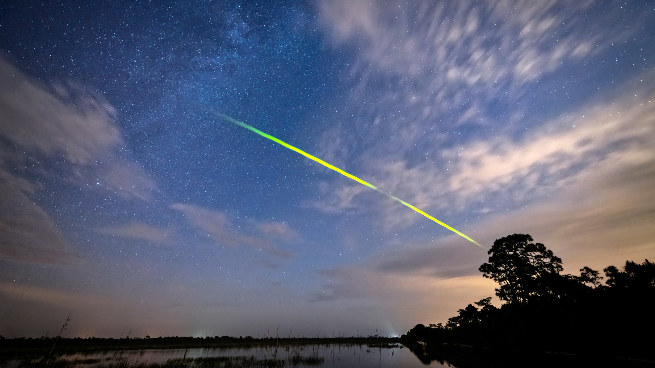 bright green streak of light in the sky.