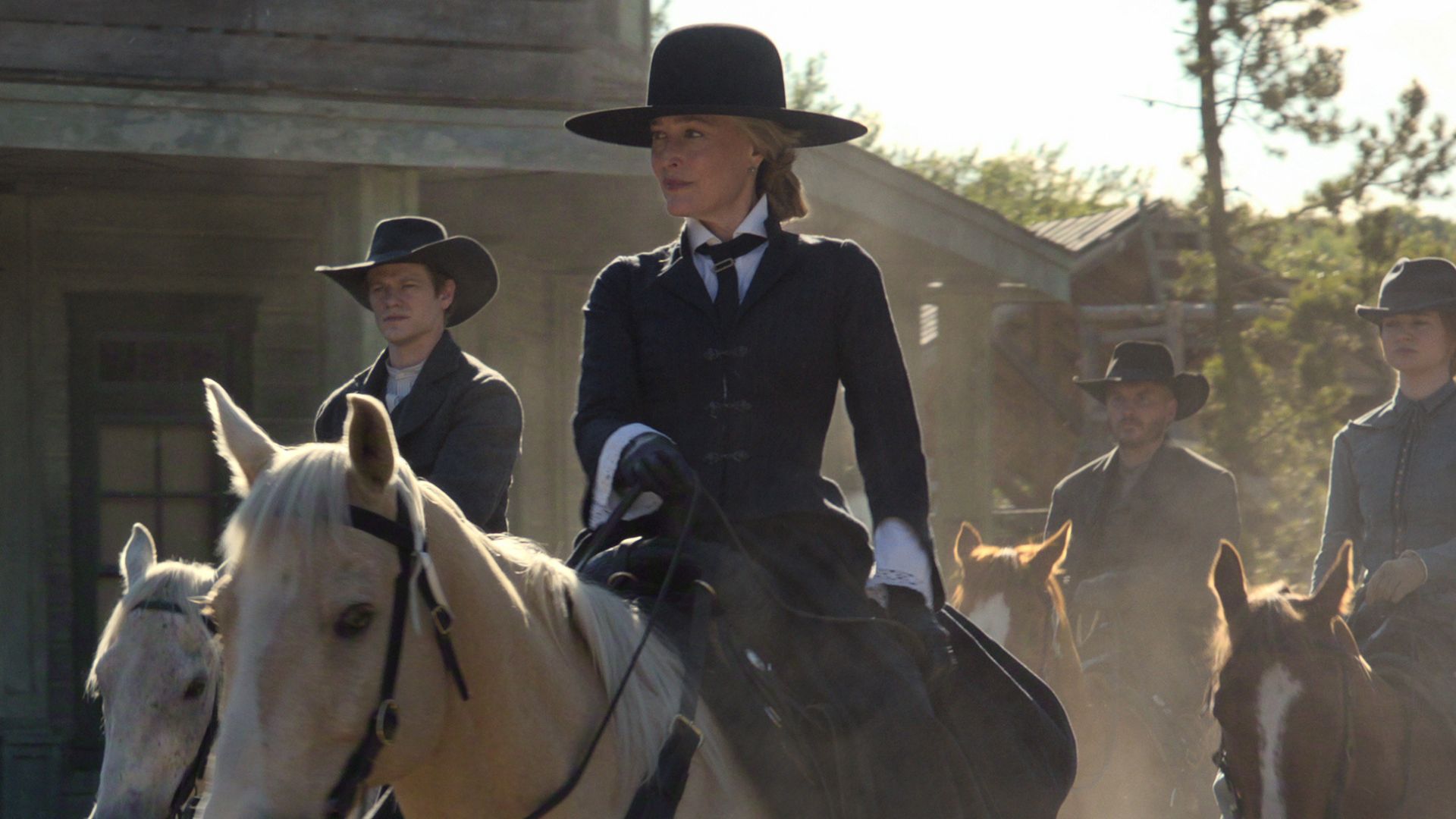 Constance Van Ness and her sons ride horses into town