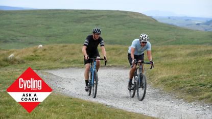 Two male cyclists riding on a gravel path