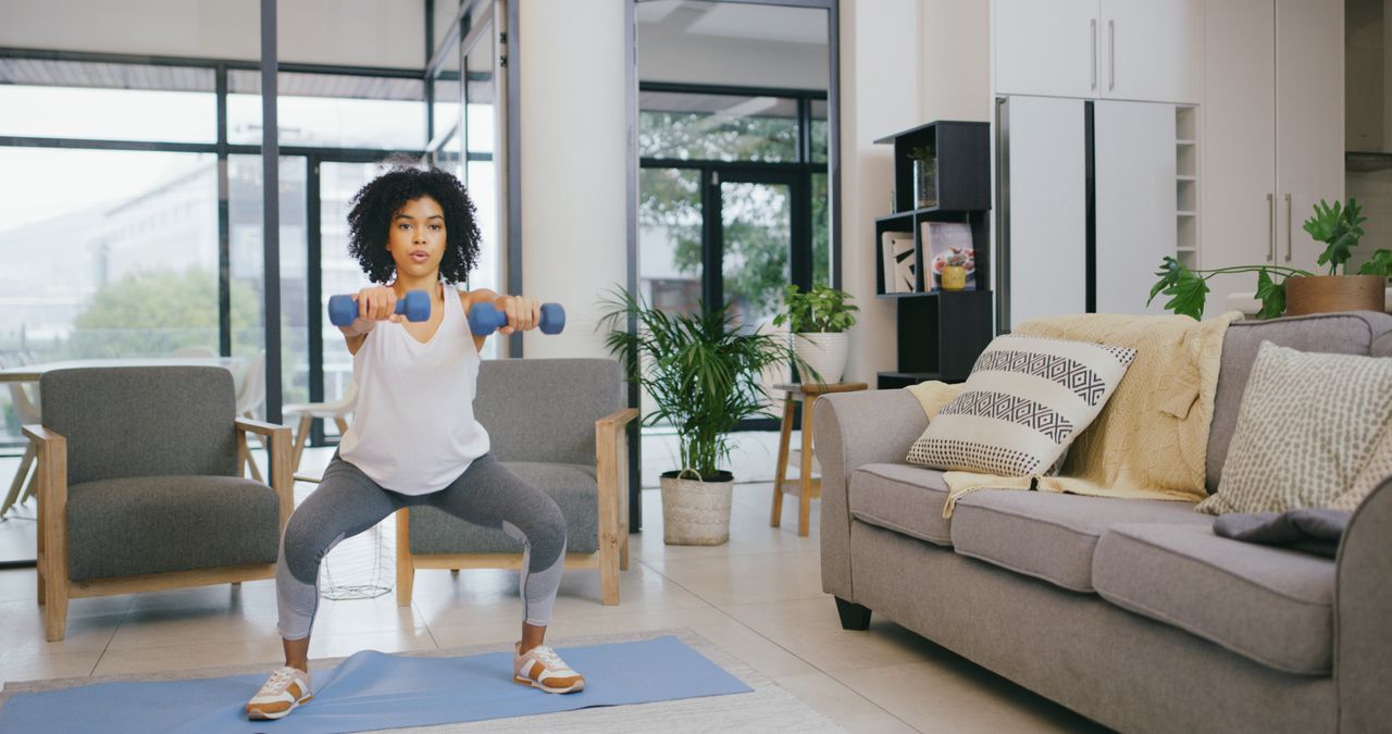 Woman completing a dumbbell workout at home