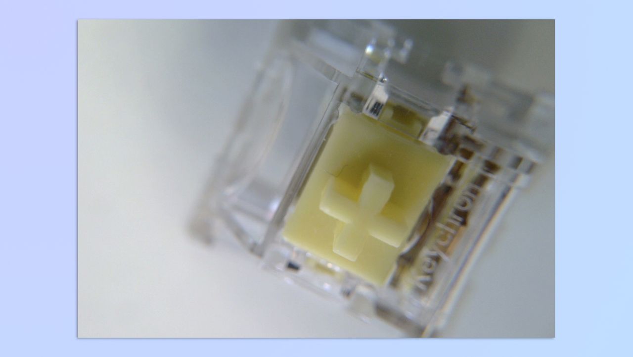 A yellow mechanical switch, shot using a BenQ ideaCam S1 Plus webcam and its 15x macro lens attachment
