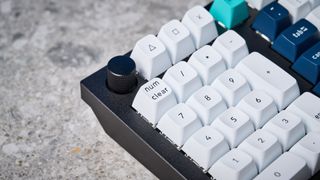 A black Keychron Q14 Max Alice keyboard with white, blue and teal keycaps